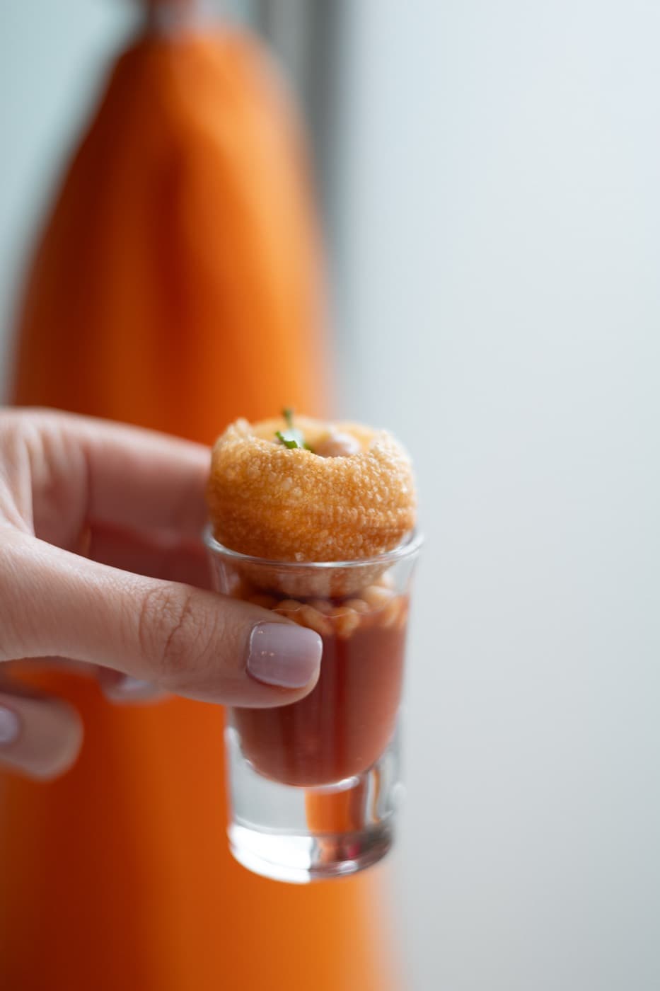 Single pani puri shot filled with tamarind water at Jewel of India